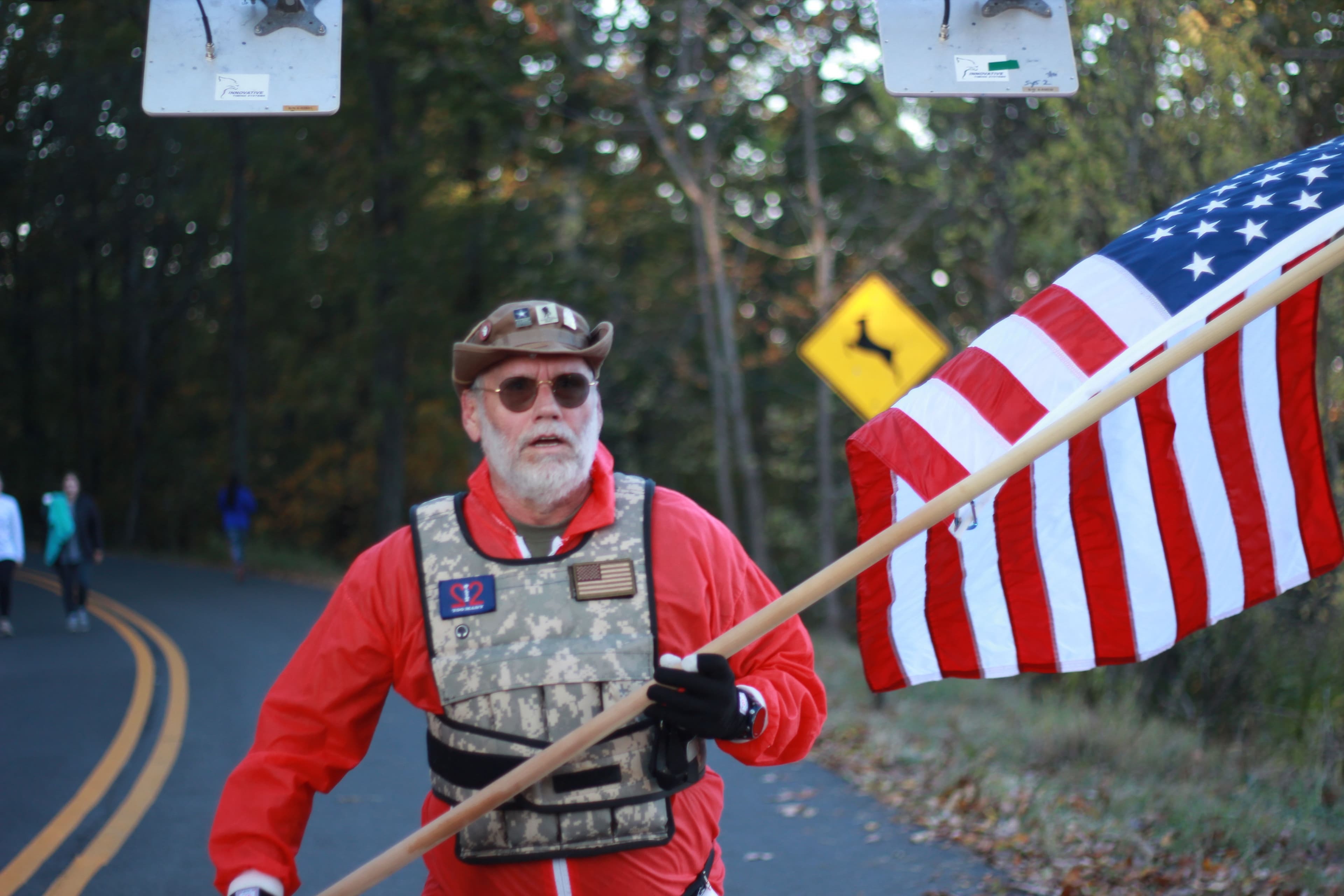 Runner carrying an American flag during the Assault on Kennesaw Mountain 5K